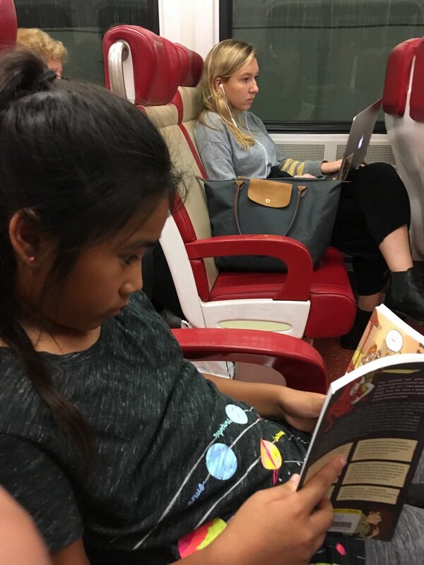 Beatrice reading on train